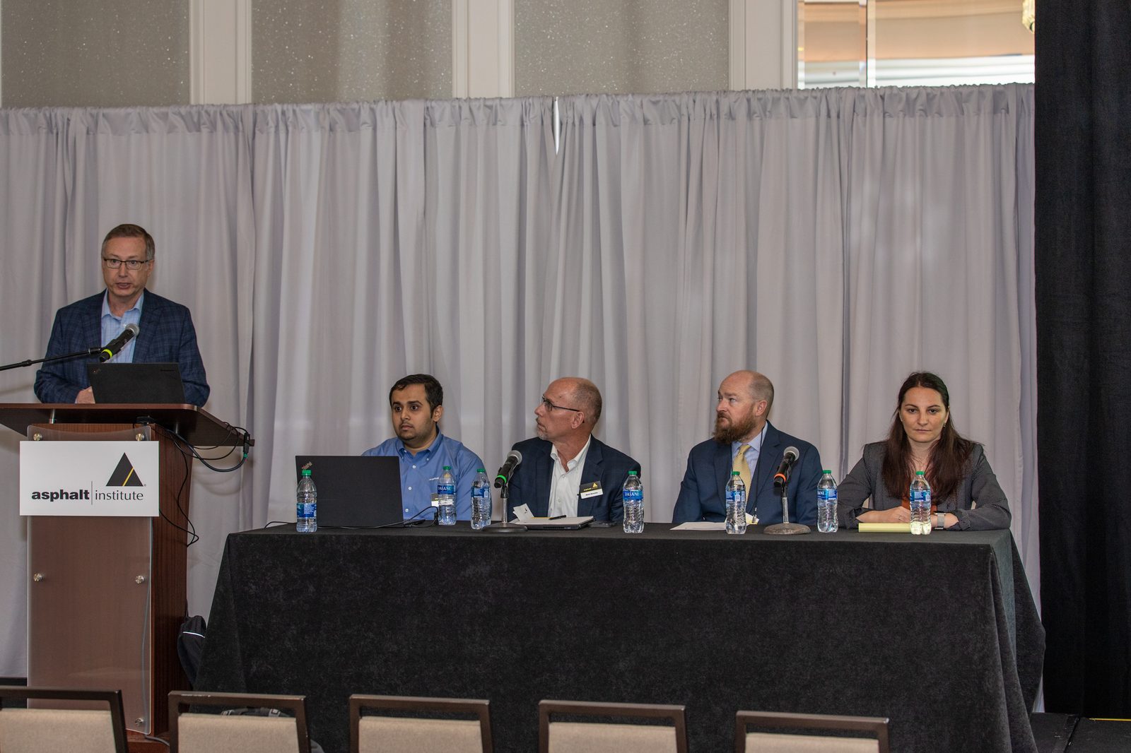 Dr. Bhat moderating an industry panel at the podium